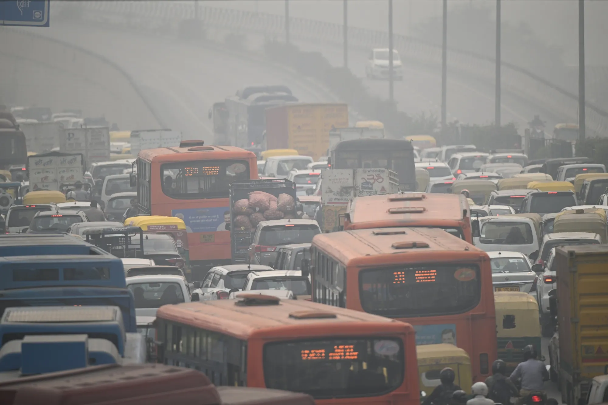 Traffic travelling along a highway amid heavy smog and pollution in New Delhi, India.