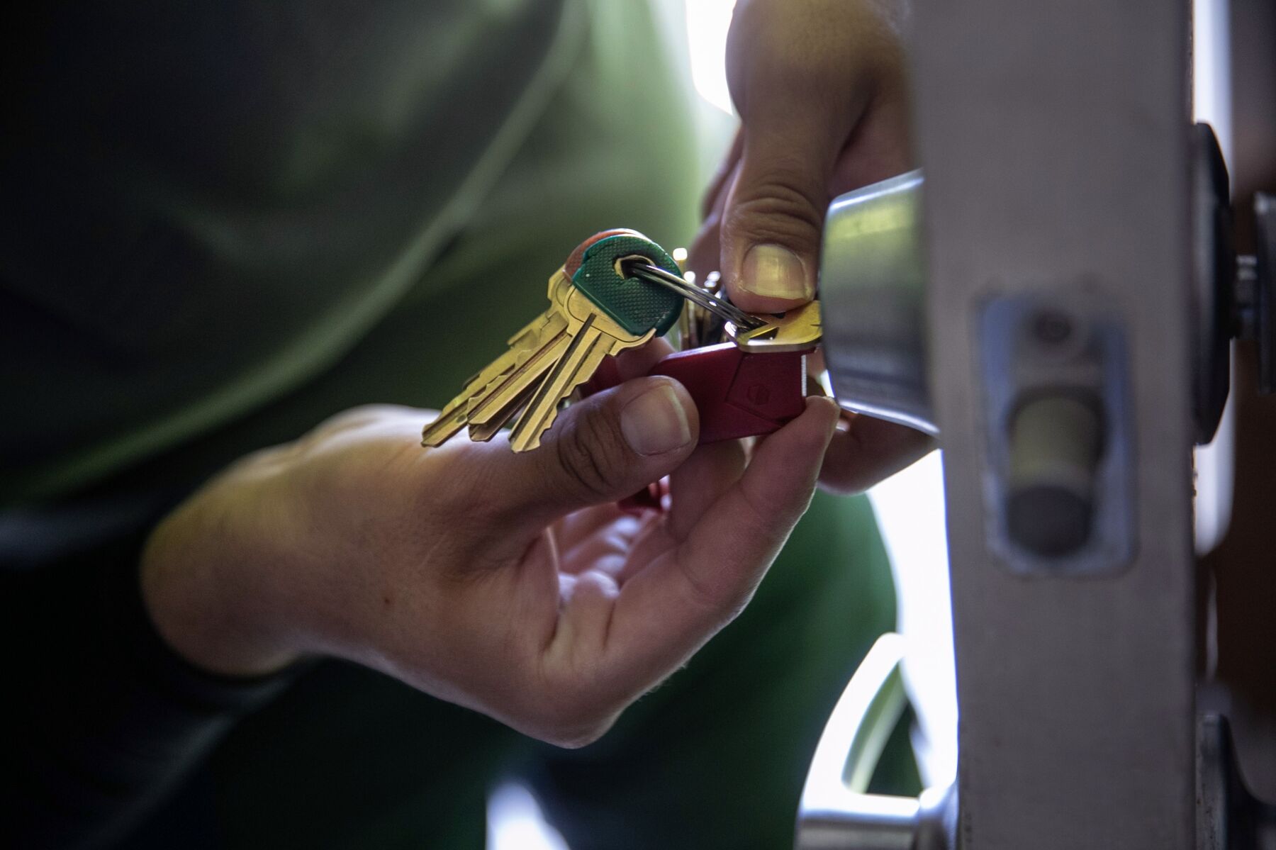 An apartment maintenance worker changes the lock of an apartment after constables posted an eviction order in October 2020 in Phoenix, Arizona. 