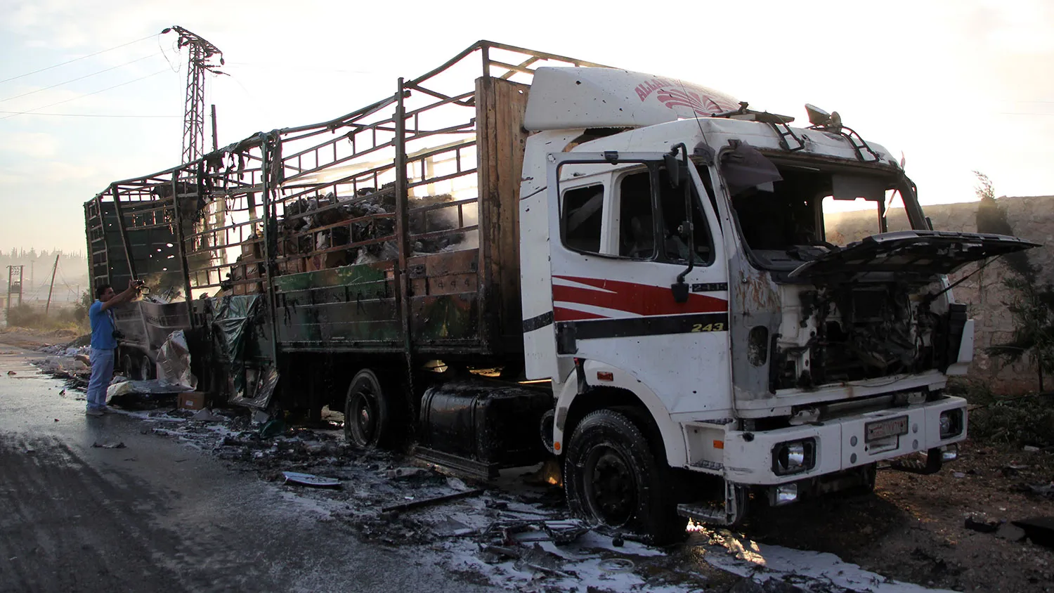 A damaged truck carrying aid is seen on the side of the road in the town of Orum al-Kubra on the western outskirts of the northern Syrian city of Aleppo on Sept. 20, 2016, the morning after a convoy delivering aid was hit by a deadly air strike.
