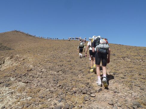 Competitors scale Hered Asfer Jebel, a hill in the Moroccan Sahara, on the second stage of the Marathon des Sables.