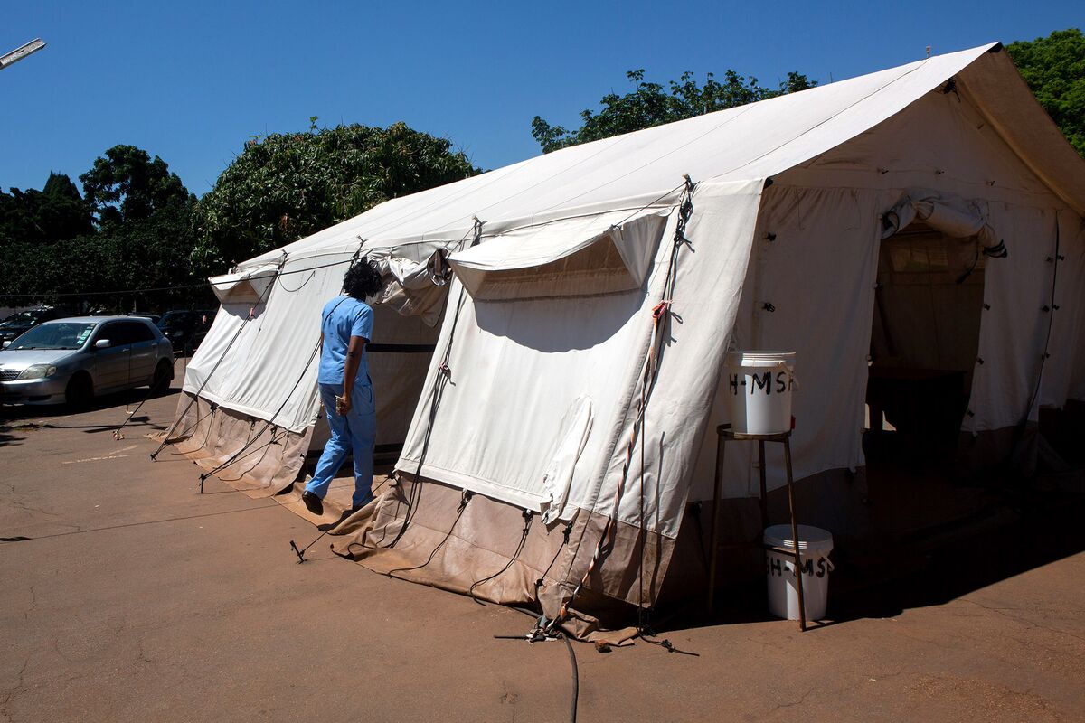 A nurse enters a vaccination tent at Parirenyatwa group of hospitals in Harare, Zimbabwe, on Dec. 1.