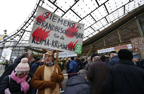 Siemens CEO Faces Down Protesters, Signals Tough Year Ahead