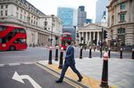A commuter walks past the Bank of England in the City of London, U.K., on Monday, Oct. 12, 2020. 