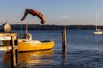 A man somersaults into the fjord for an evening swim on Lindoya island in Oslo.