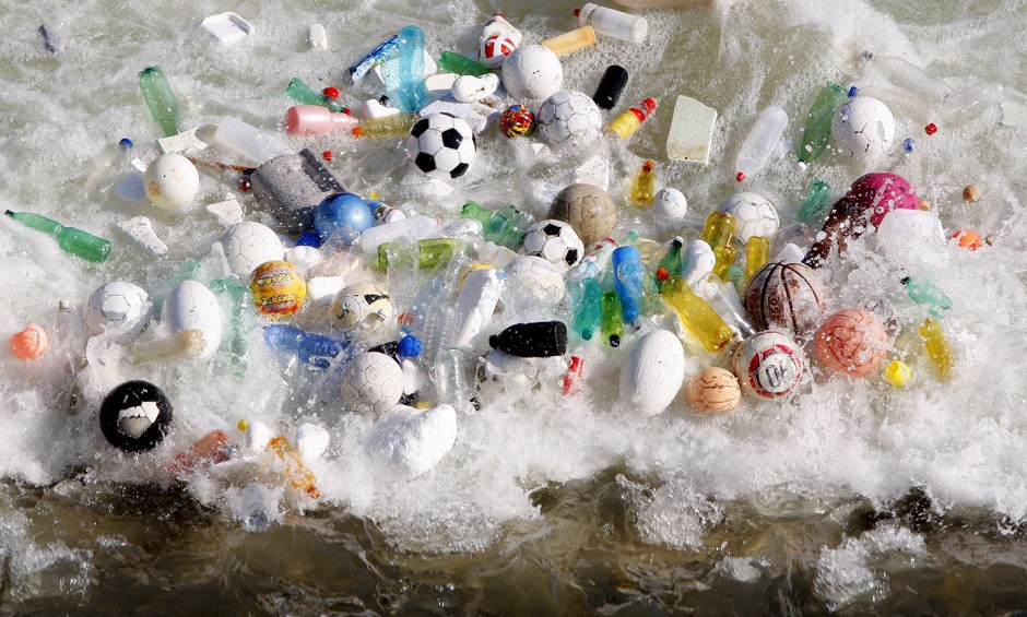 Sports balls, and plastic bottles and other litter is accumulated by currents in the Tiber River in central Rome in 2008.