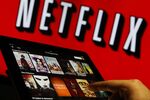 A man scrolls through a selection of viewing choices on the Netflix Inc. app.