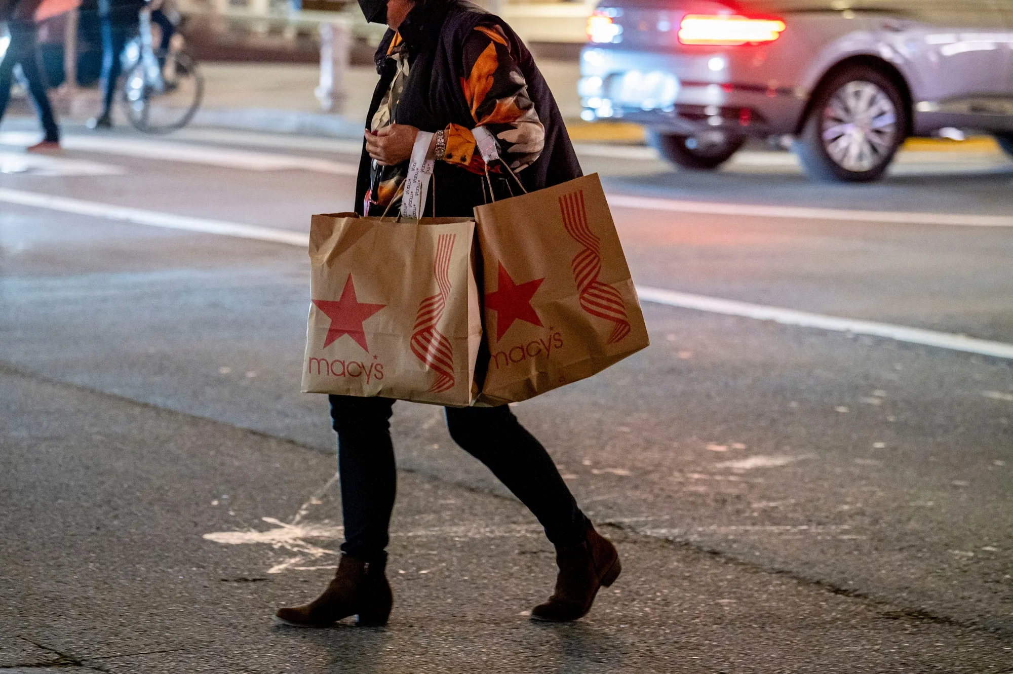 A shopper carries Macy's bags in San Francisco, California.