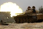 Fighters loyal to the Government of National Accord open tank fire in&nbsp;the al-Sawani area south of Tripoli during clashes with forces loyal to Khalifa Haftar&nbsp;on June 13.