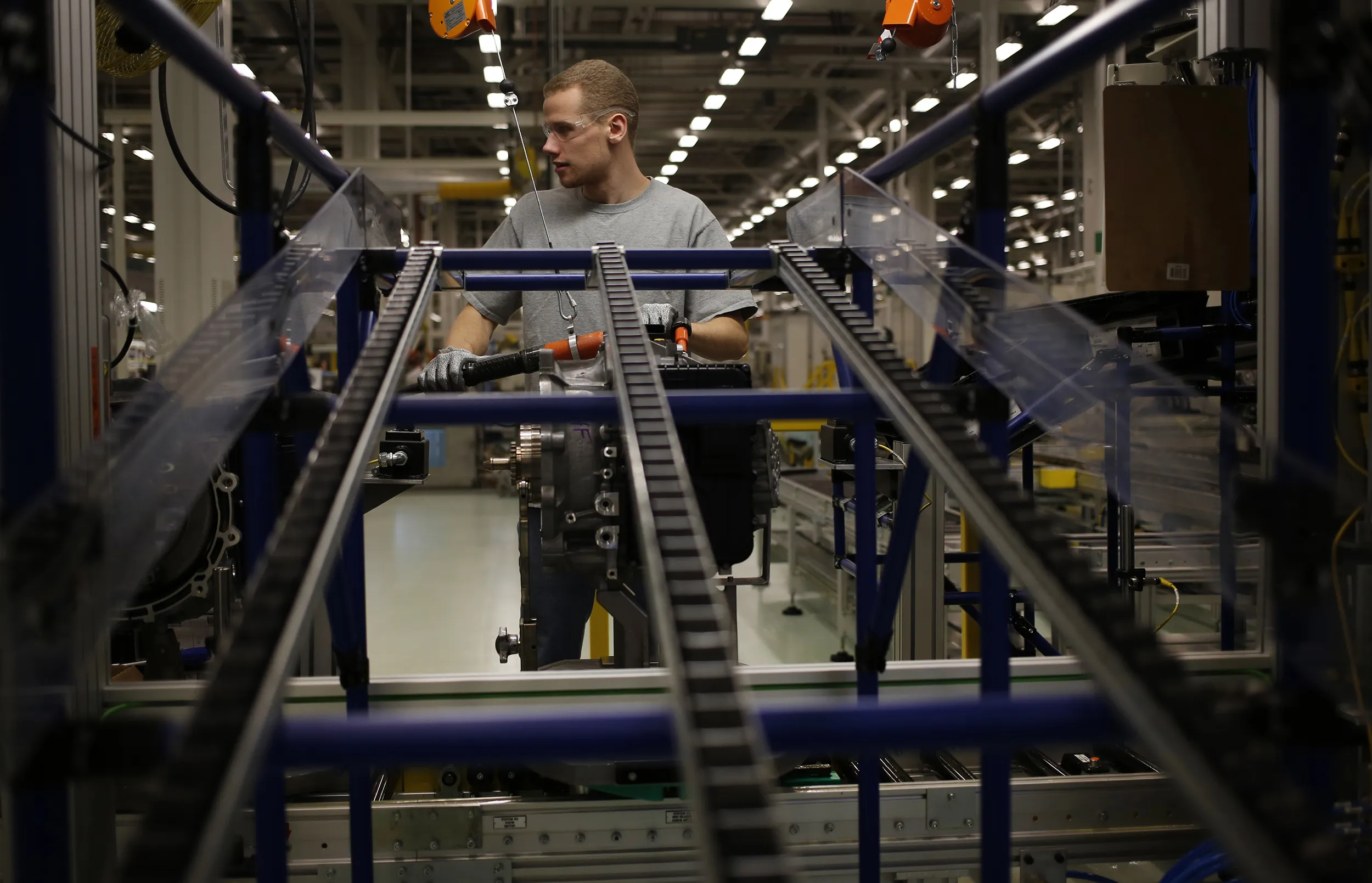 A factory worker assembles transmission components for Chrysler Group LLC vehicles in Tipton, Indiana.
