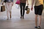 Shoppers carry bags while walking through the Scottsdale Quarter shopping mall in Scottsdale, Arizona, U.S., on Tuesday, April 11, 2017. The U.S. Census Bureau is scheduled to release retail sales figures on April 14.
