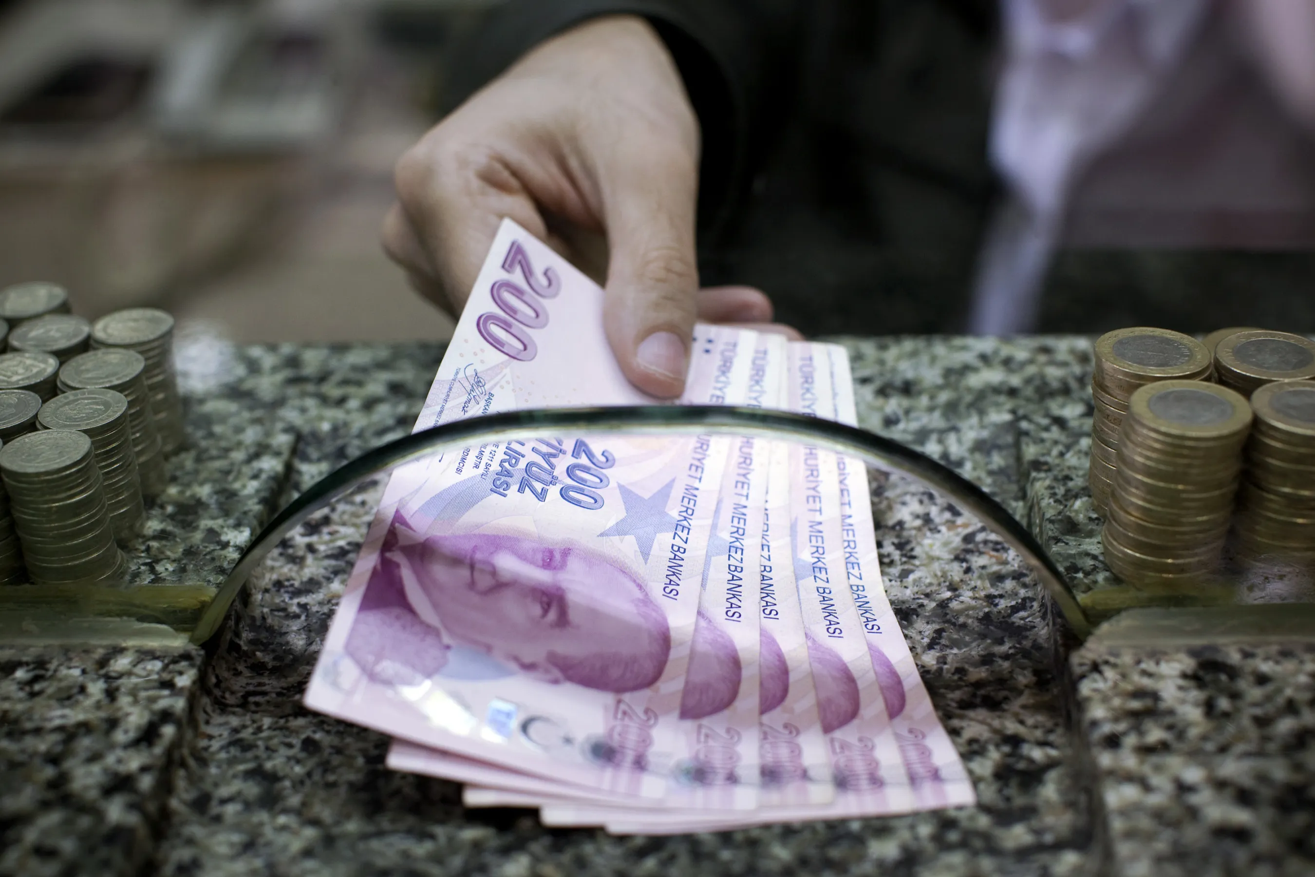 Turkish 200 lira bank notes are exchanged on a currency store counter.