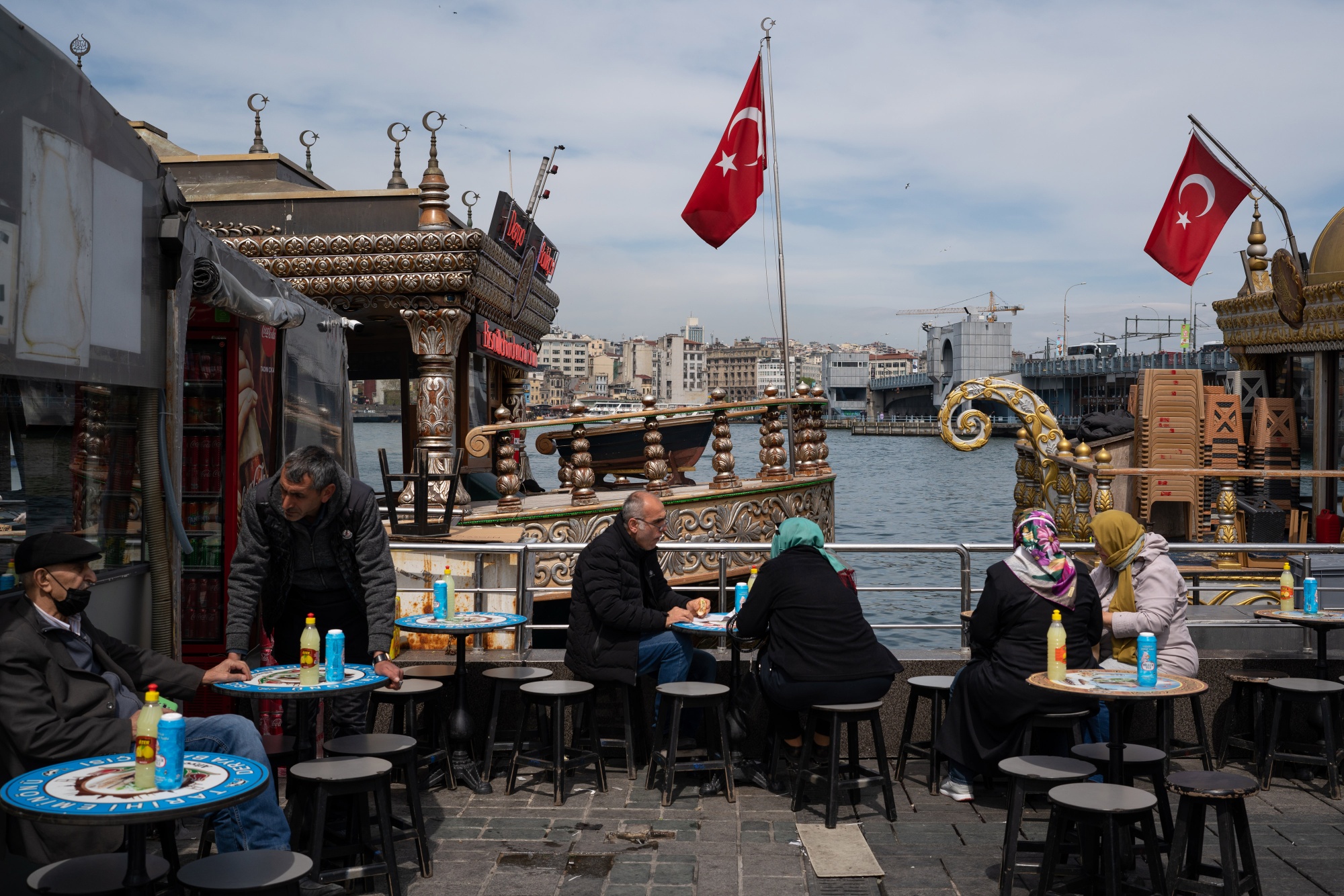 Diners at a terrace outside a port-side cafe in Istanbul.