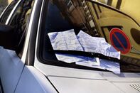 Many fines on the windscreen of a parked car