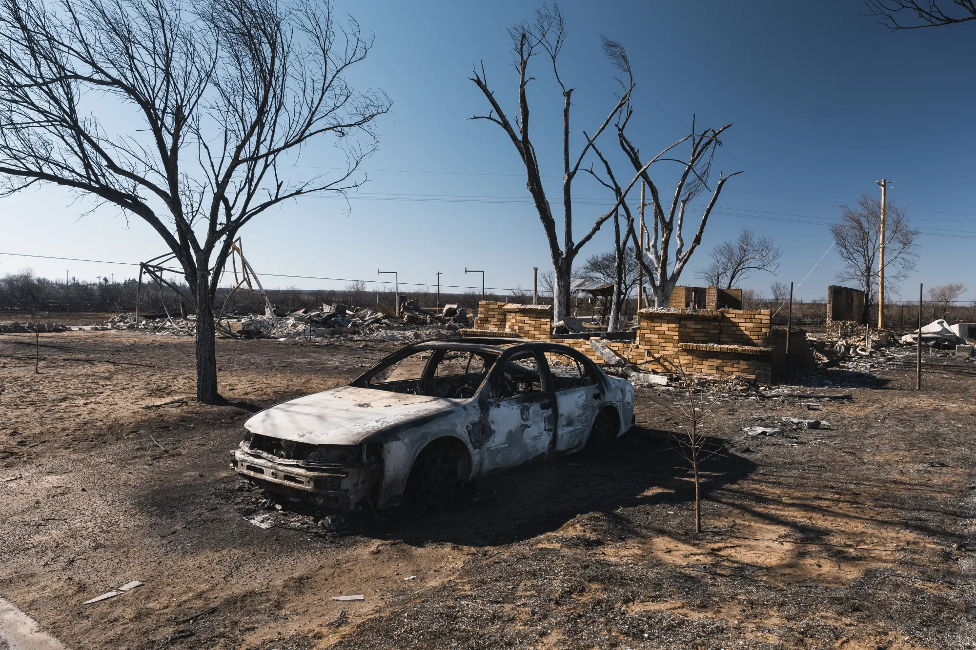 A burned car and home following the Smokehouse Creek Fire in Fritch, Texas, on&nbsp;March 1.