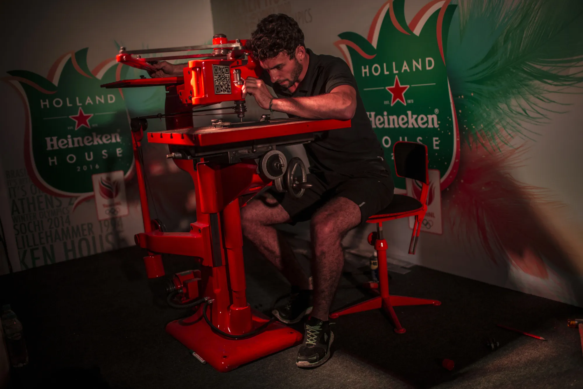 An employee engraves a gift for an athlete during a celebration at Holland Heineken NV House in Rio de Janeiro, Brazil, on Wednesday, Aug. 10, 2016. Staffed by 300 paid employees plus volunteers in collaboration with the Netherlands Olympic Committee, Holland House has two floors, several dining areas, a pool and nightclub. Some 75,000 visitors are expected to stop by before the end of the games. Photographer: Dado Galdieri/Bloomberg
