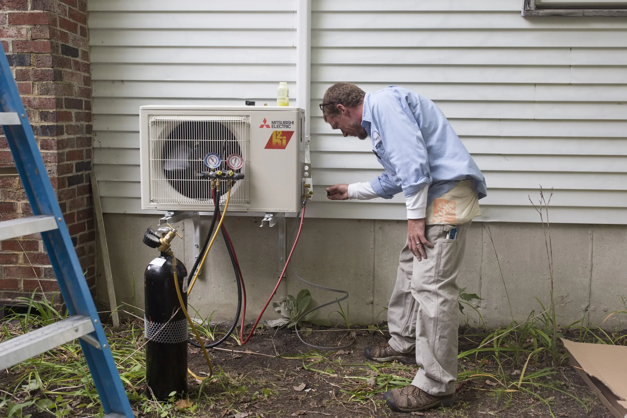 A worker installs a heat pump at a home in Standish, Maine.&nbsp;