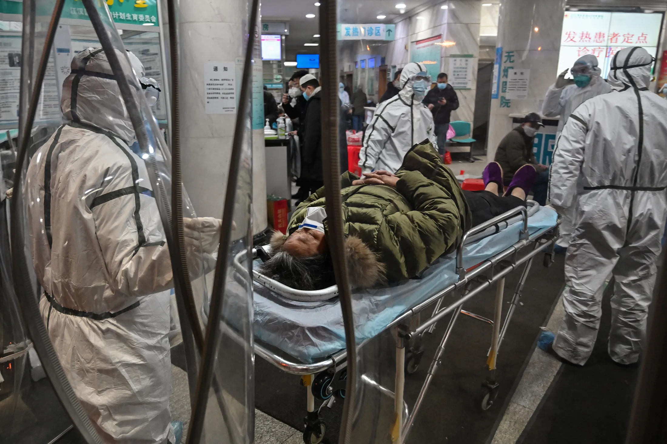 Medical staff members wearing protective clothing&nbsp;arrive with a patient at the Wuhan Red Cross Hospital in Wuhan on Jan.&nbsp;25.