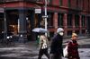 Pedestrians wearing protective masks pass in front of an Etro USA Inc. store in the SoHo neighborhood of New York, U.S., on Monday, Dec. 14, 2020. The U.S. Census Bureau is scheduled to release retail sales figures on December 16.