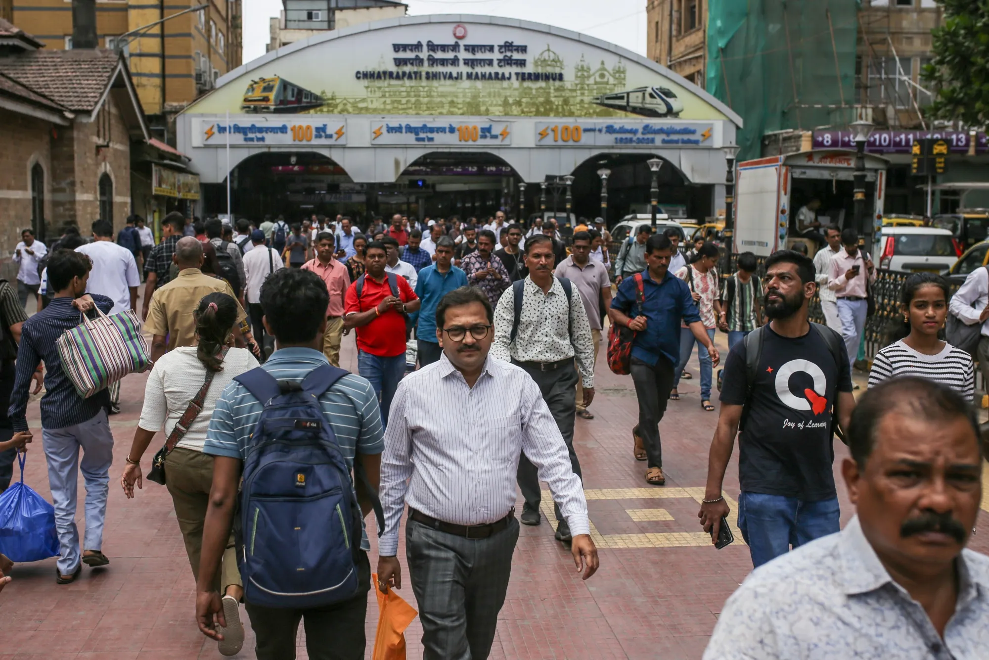 Commuters outside the Chhatrapati Shivaji Maharaj Railway Terminus in Mumbai.