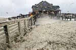 High winds blow sea foam onto Jeanette's Pier in Nags Head, N.C., on Oct. 28 as wind and rain from Hurricane Sandy move into the area. Governors from North Carolina to Connecticut declared states of emergency