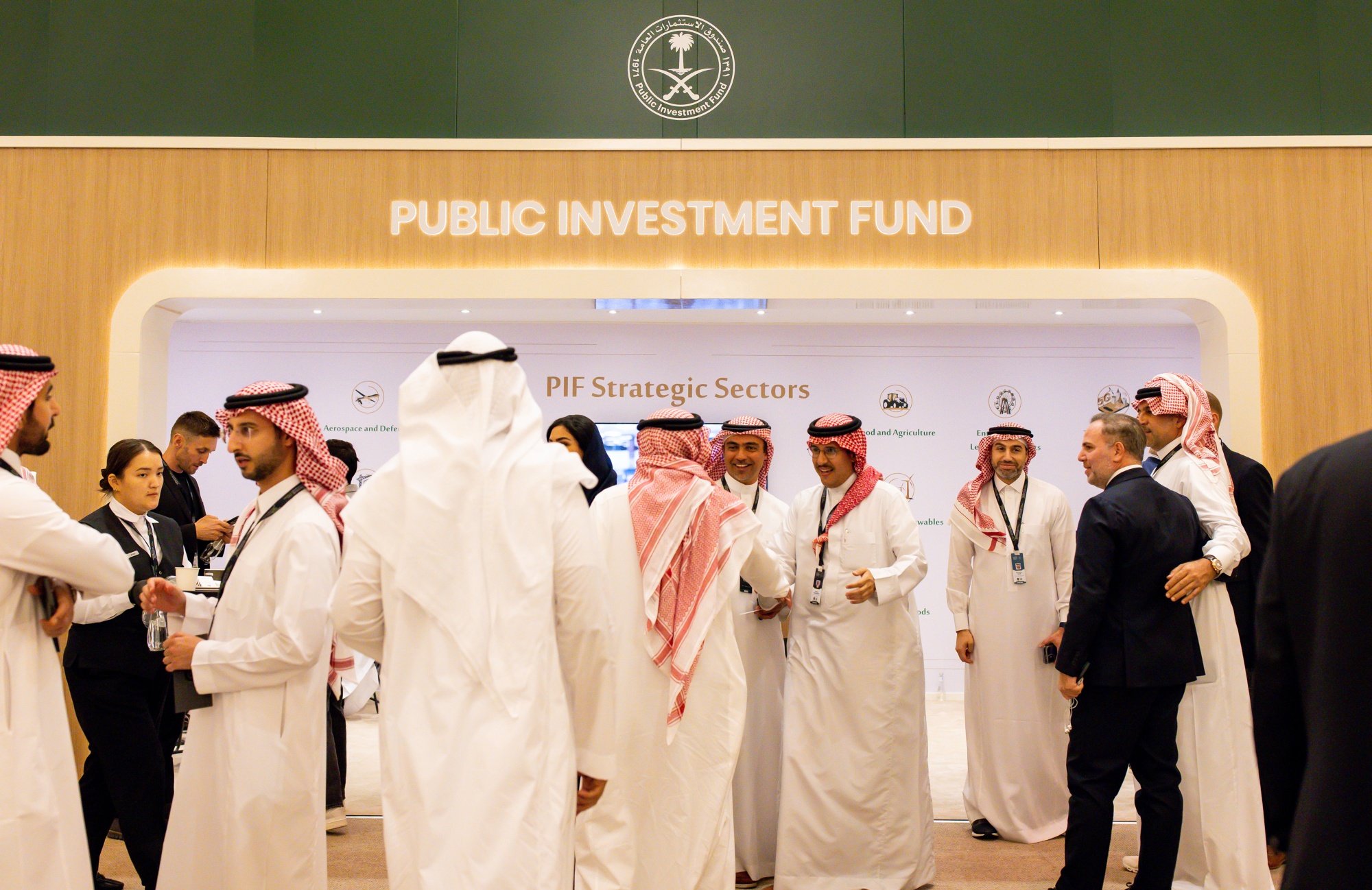 Attendees visit the Public Investment Fund booth at the Future Investment Initiative conference in Riyadh, Saudi Arabia.