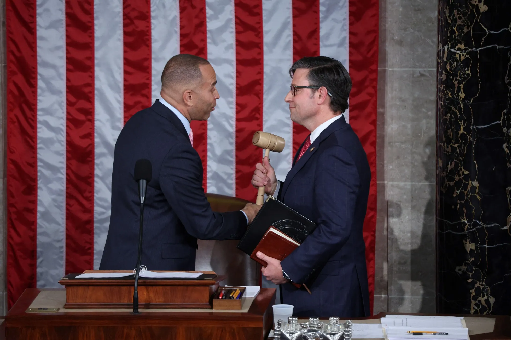 Hakeem Jeffries&nbsp;hands&nbsp;Mike Johnson the gavel at the US Capitol in Washington, DC&nbsp;on October 25.