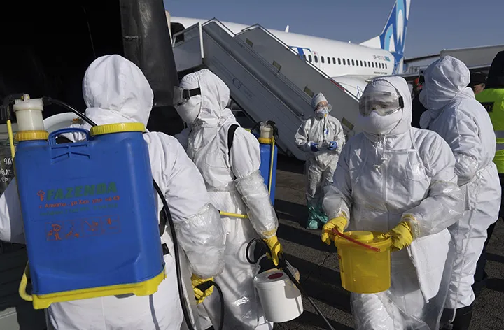 Workers sanitize an airplane in Alma-Ata, Kazakhstan, on Jan. 24.&nbsp;