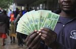 A man shows the new notes introduced by the Reserve Bank of Zimbabwe in Harare, on Nov. 28, 2016.
