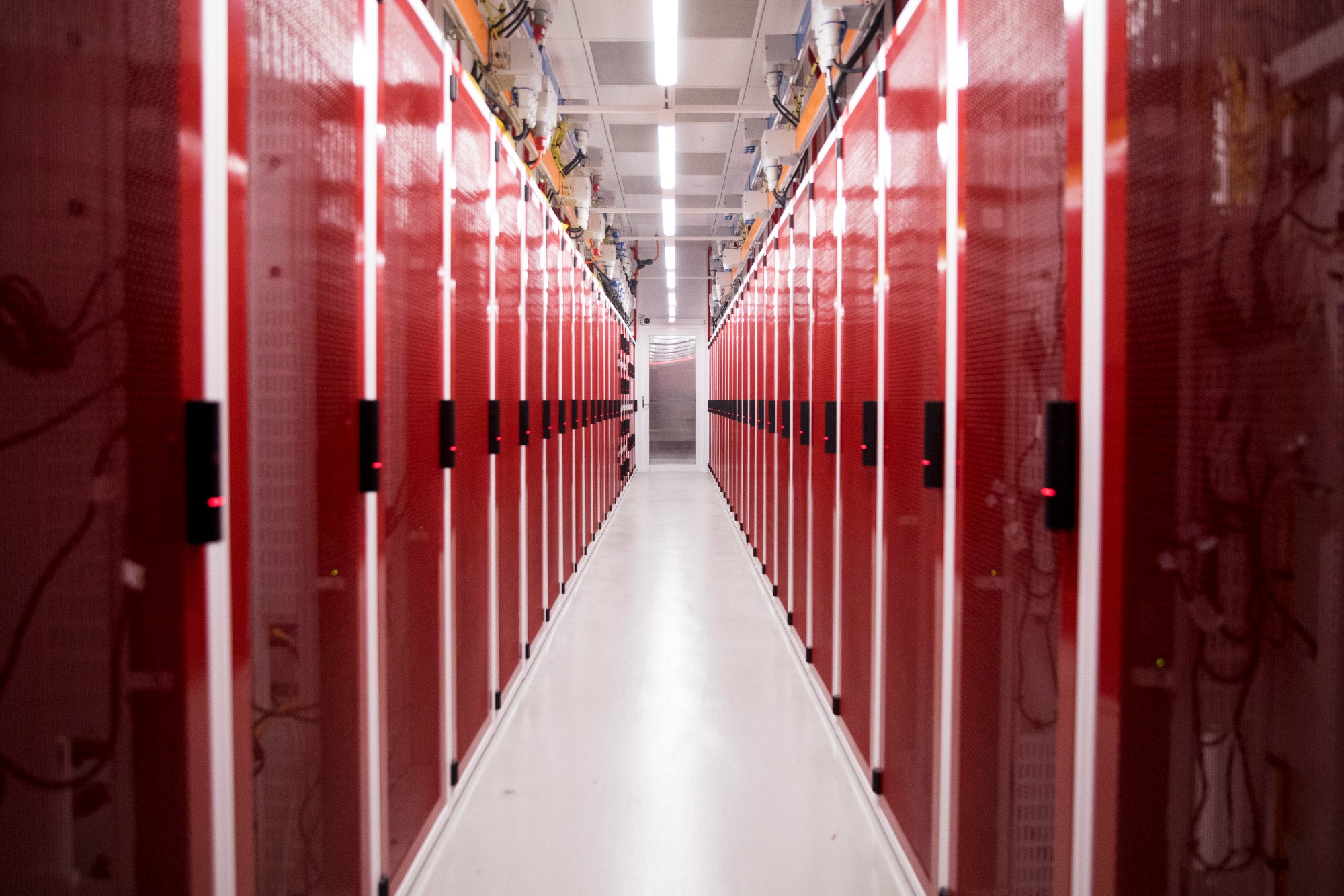 Cabinets housing servers inside a data hall at a NextDC Ltd. data center in Sydney, Australia, on Monday, Dec. 8, 2025. OpenAI partnered with Australian data center operator NextDC to build a A$7 billion ($4.6 billion) large-scale computing cluster in Sydney, accelerating its expansion in the Asia-Pacific region. Photographer: Brent Lewin/Bloomberg