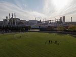 A family plays soccer at Salina Elementary, next to the Dearborn Industrial natural-gas-powered electricity-generating facility.