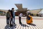 Visitors interact with an autonomous robot on the opening day of the Expo 2020 exhibition in Dubai earlier in October. 