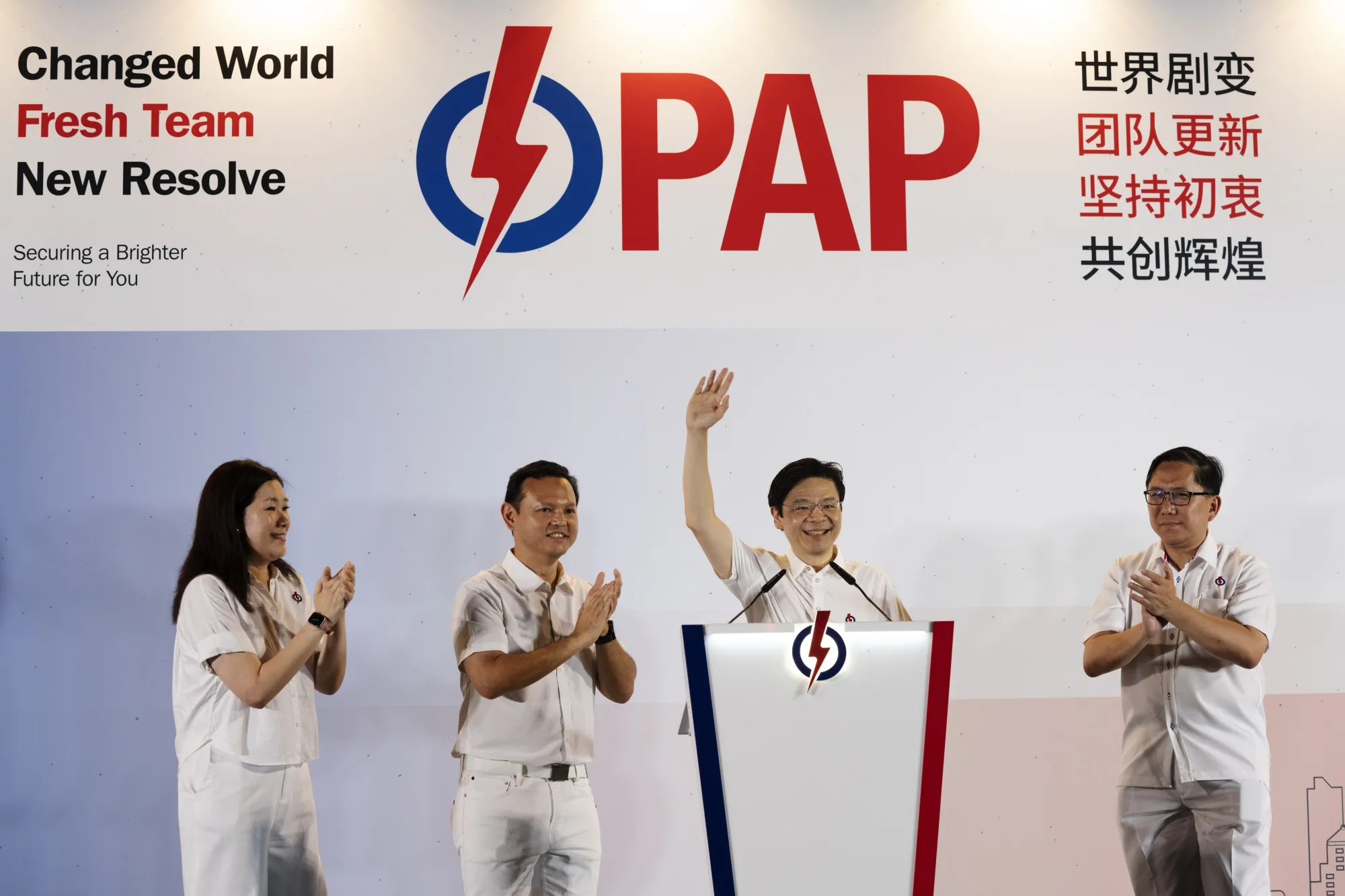 Lawrence Wong, second right, waves to the crowd at an election night event in Singapore, early on May 4.
