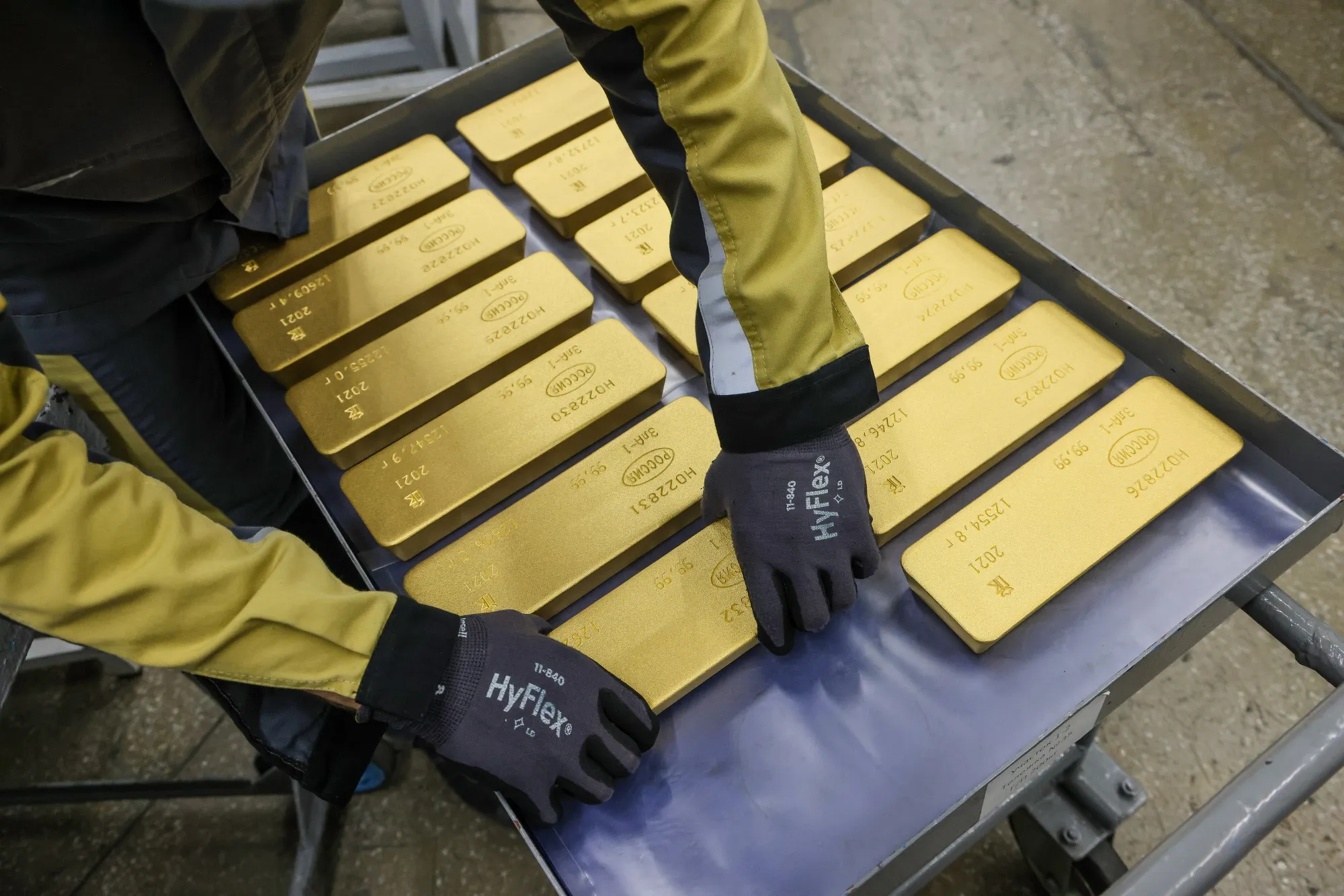 A worker loads gold ingots onto a trolley ready for distribution in Krasnoyarsk, Russia.