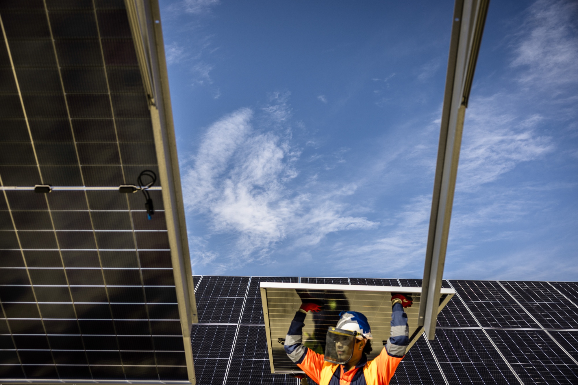 A worker installs a solar panel at the Fuendetodos II solar park, operated by Zelestra Corp. SA, in Villanueva de Huerva, near Zaragoza, Spain, on Wednesday, March 25, 2026. Renewables are helping cushion the blow of higher oil and gas prices in Europe. Photographer: Angel Garcia/Bloomberg