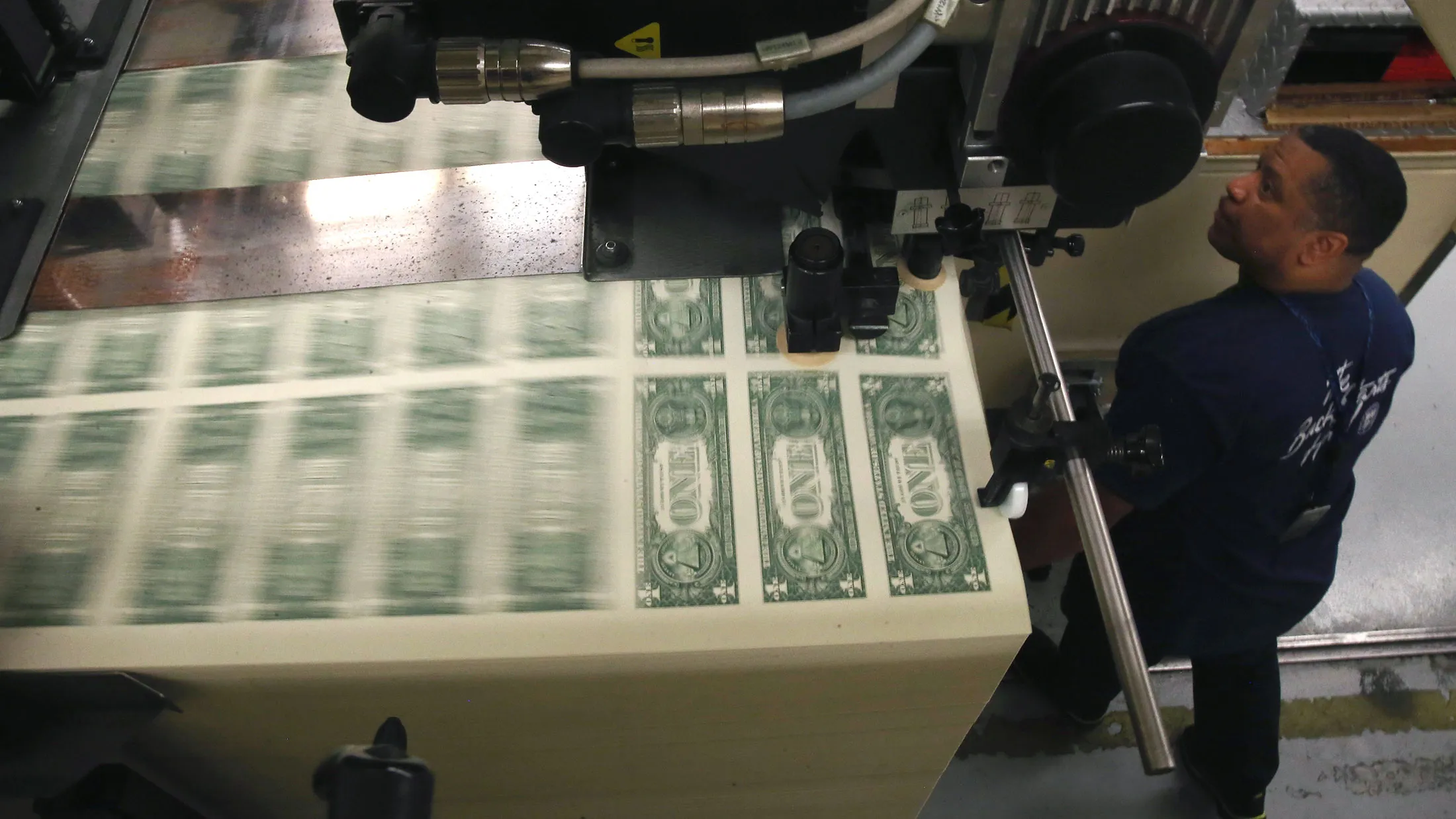 A press printing one dollar bills at the Bureau of Engraving and Printing in Washington, DC.
