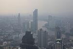 Buildings stand shrouded in smog along the Chao Phraya river in Bangkok.