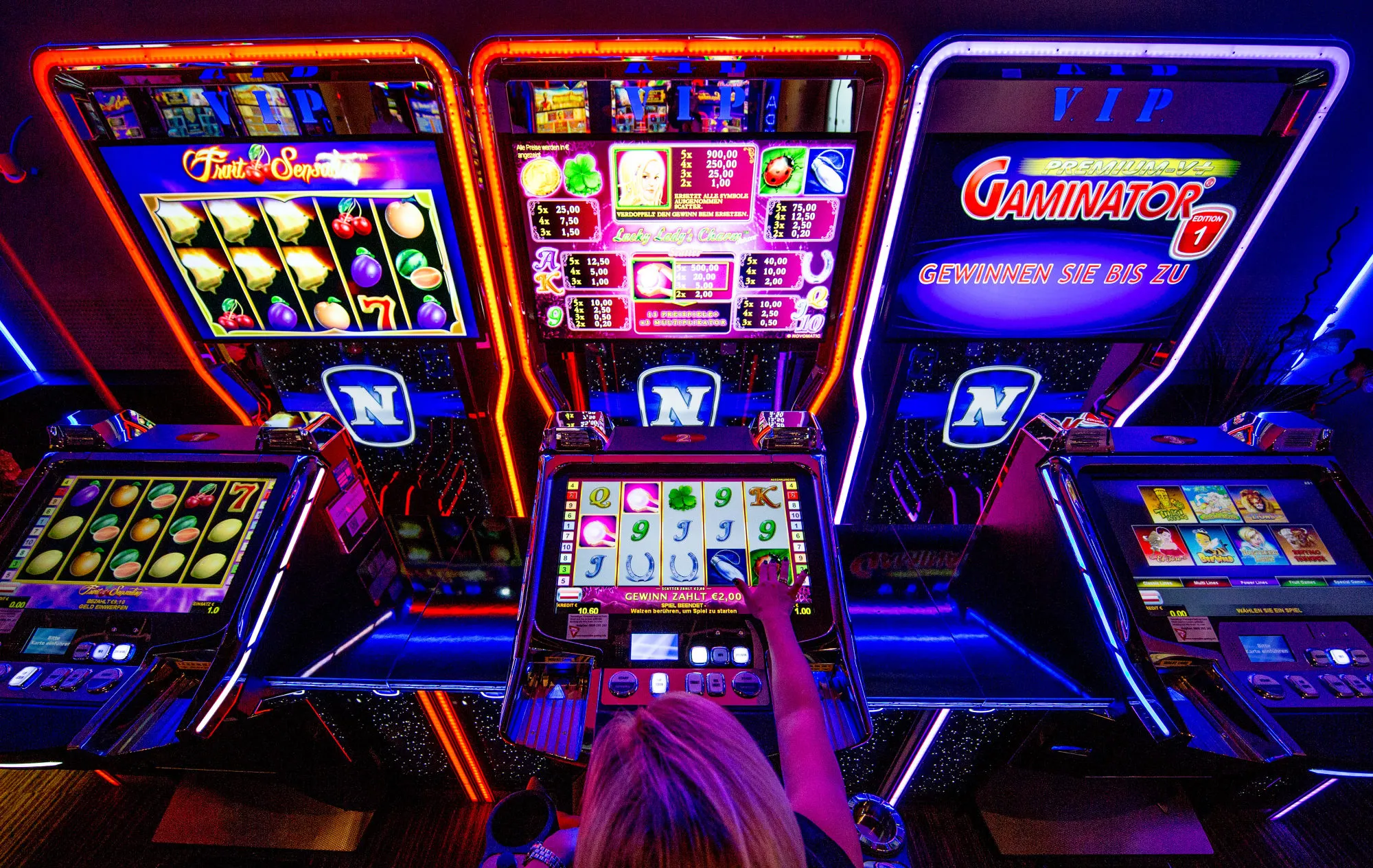 A customer plays on a Novomatic electronic slot machine in Wiener Neudorf, Austria