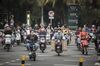 Motorists ride through an intersection in Haikou, China, on Monday, March 12, 2018. Policy makers' pledges to support China's economy will help boost liquidity in the nation's capital markets, according to central bank adviser Ma Jun.
