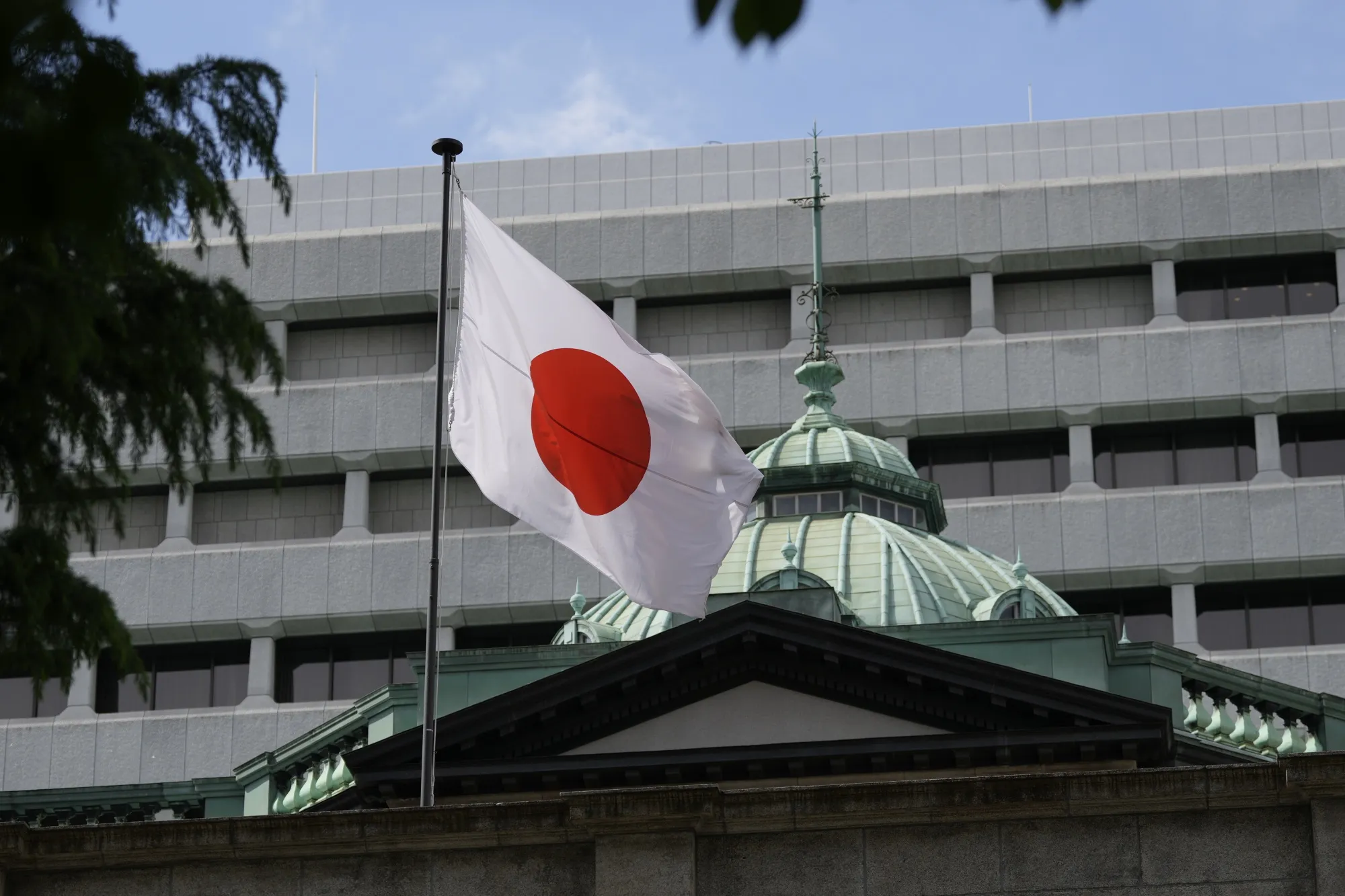 A Japanese flag outside the Bank of Japan (BOJ) headquarters in Tokyo.