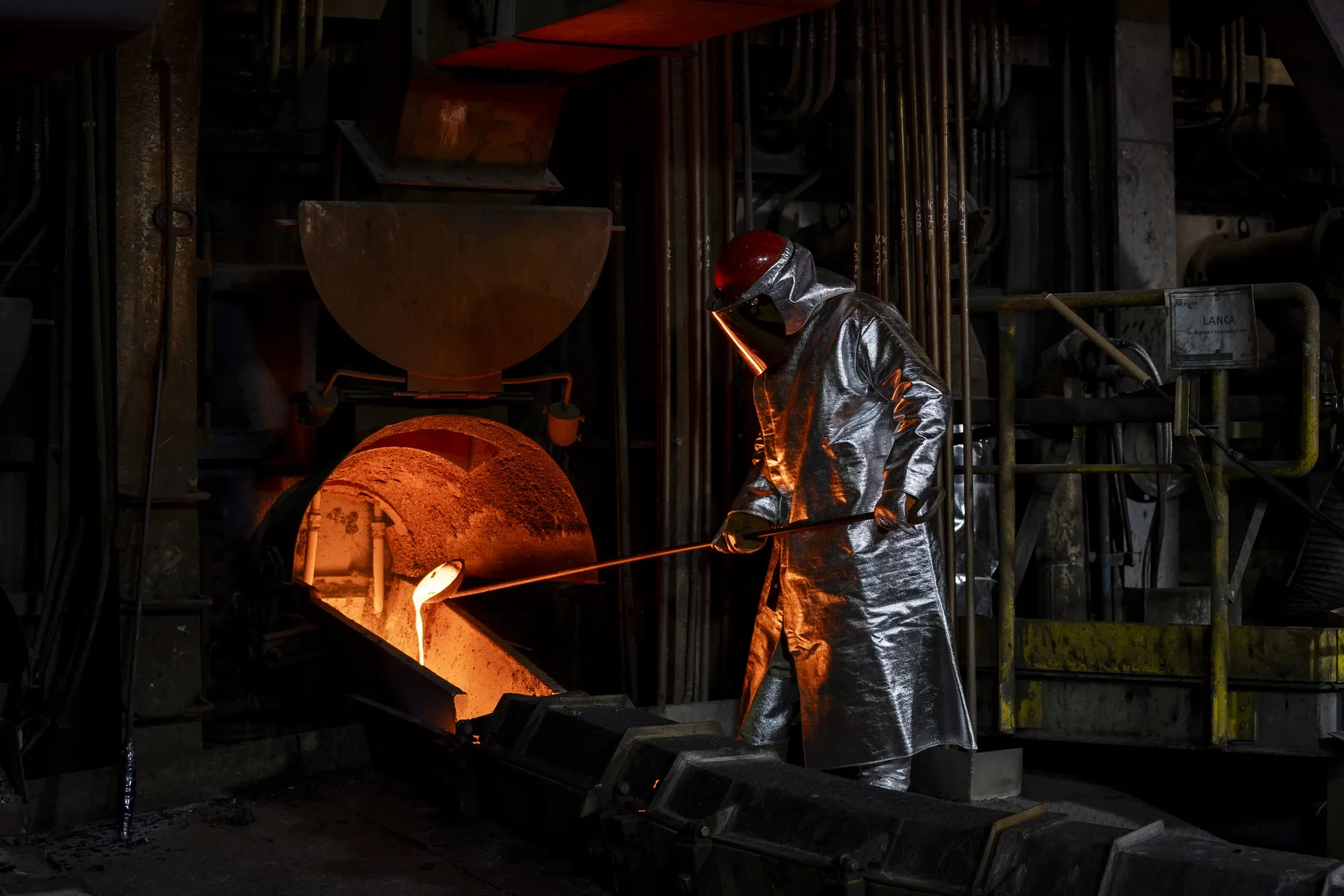 A worker heats copper in a smelter at a foundry.