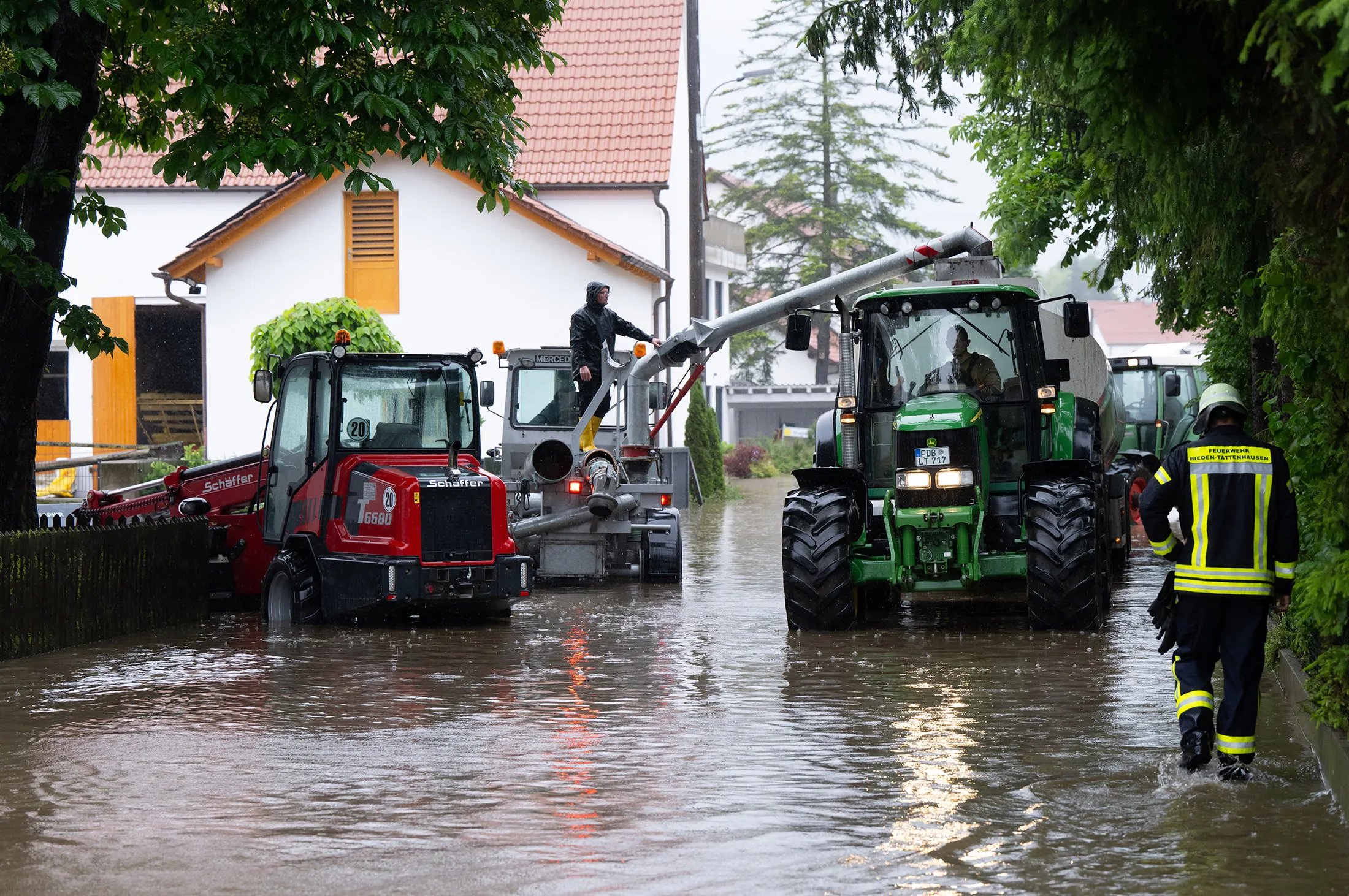Firefighters and volunteers pump the flood water into tankers in Dasing, Bavaria, Germany, on June 1.