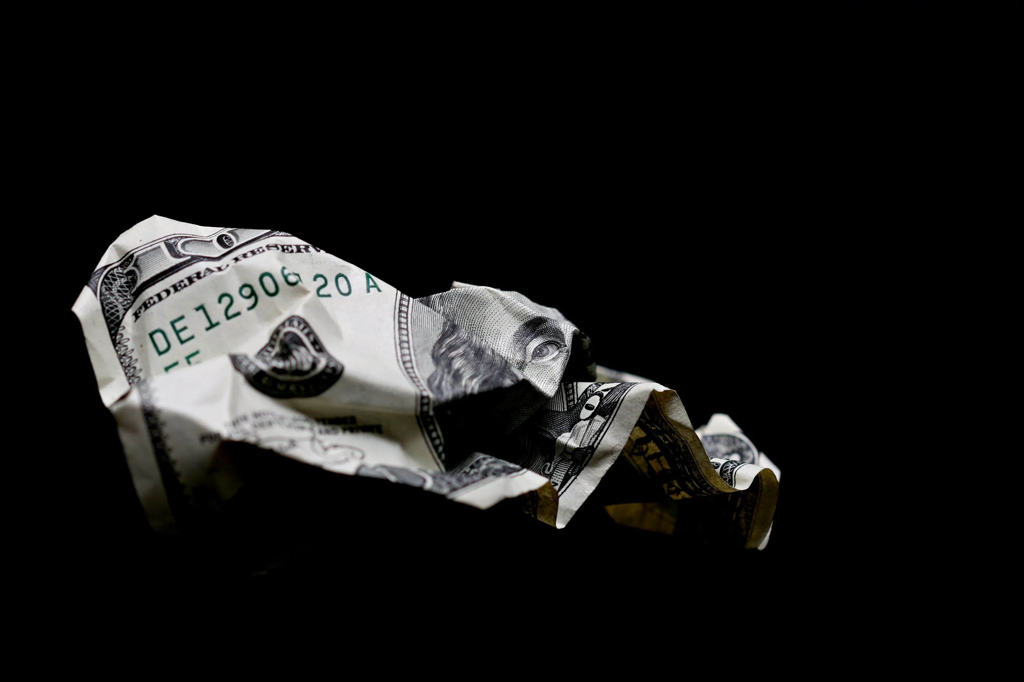 crumpled hundred dollar bill