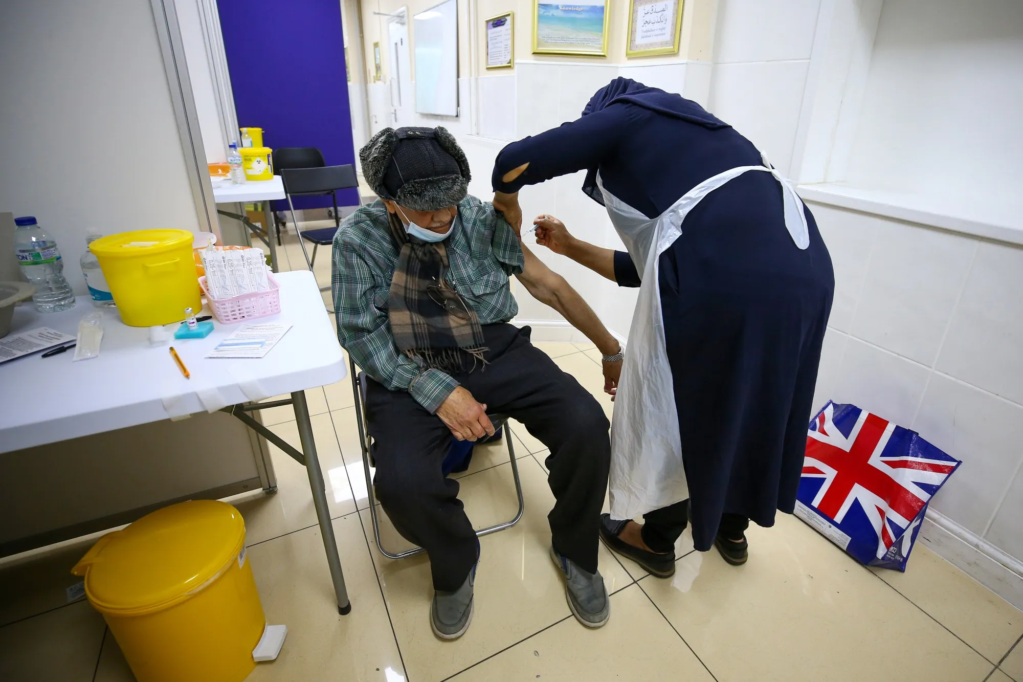 A man receives a dose of the AstraZeneca Covid-19 vaccine at Central Mosque of Brent in London March 19.