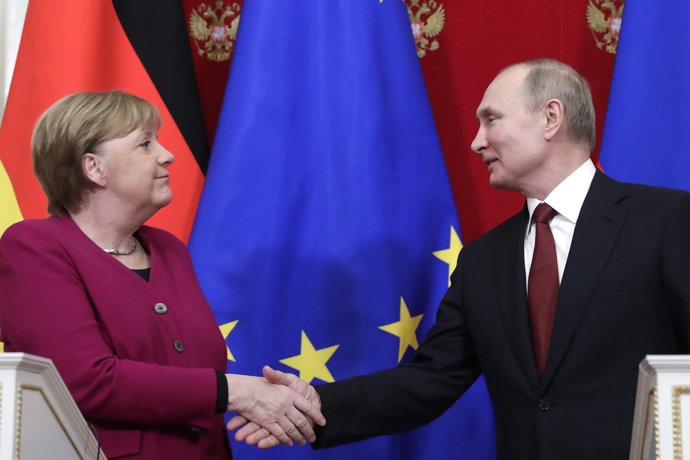 Merkel and Putin shake hands during a joint press conference in Moscow on Jan. 11.