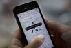 The Uber app is demonstrated in New York on Aug. 6, 2014.
