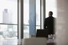 Businessman looking out conference room window