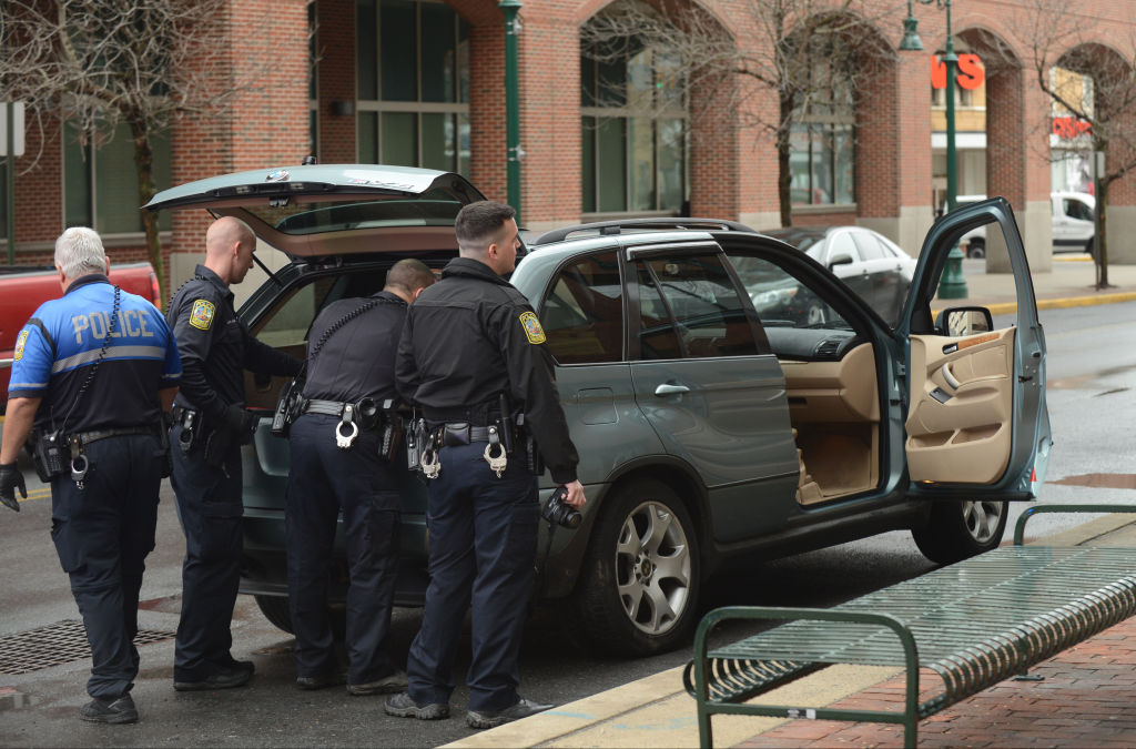 a police officer giving ticket at a intersection