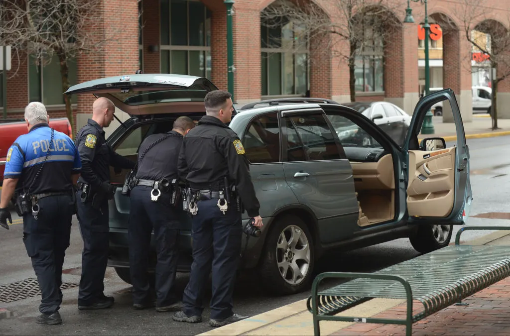Police officers search a vehicle during a traffic stop. A proposed bill in Congress wants to incentivize cities to take these stops out of police hands to reduce violent consequences.&nbsp;