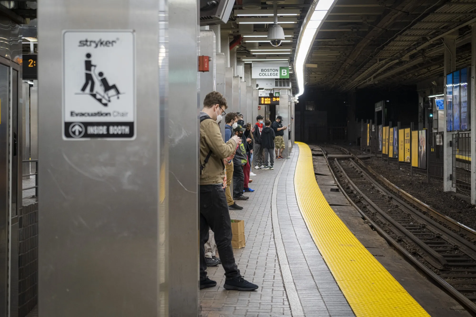 Commuters wait on a the platform of the Massachusetts Bay Transportation Authority's Park Street Station in Boston in 2022.