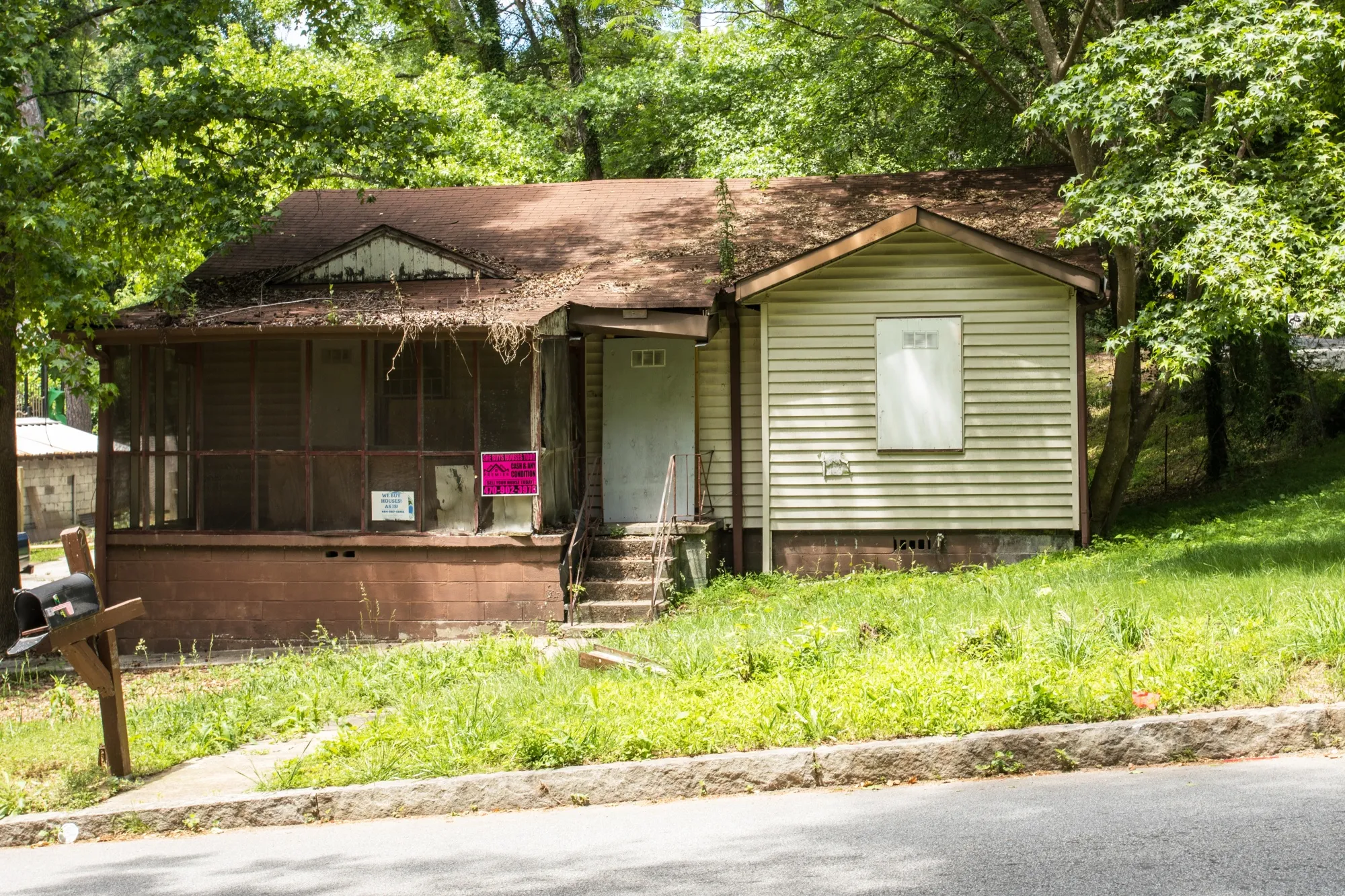 Cash-for-houses signs on a property in Atlanta’s Grove Park, heavily targeted by wholesalers.